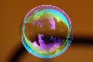 A spherical bubble suspended in the air. This bubble symbolizes a stock bubble liable to burst at any moment.