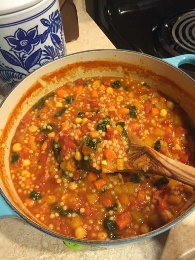 Moroccan Butternut, Chickpea, and Couscous Stew made in a light blue Le Creuset dutch oven. An example of frugal cooking.