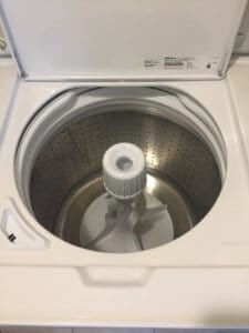 A large interior metal basin holds an agitator for the Speed Queen Washer.