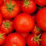 Tomatoes are pictured which are the precursor for ketchup. Kraft Heinz produces ketchup.