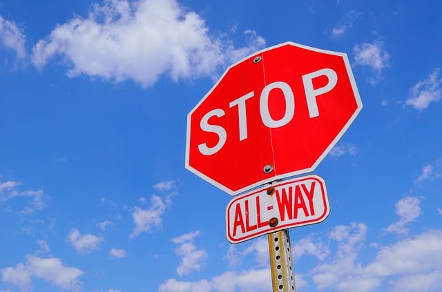 A red stop sign with the word stop in the middle and all-way below it. Picture used as an allegory for a hard investment rules.