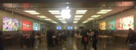 A photograph taken by an iPhone of a busy Apple storefront. Taken by Trey Henninger for used in articles about Apple stock.